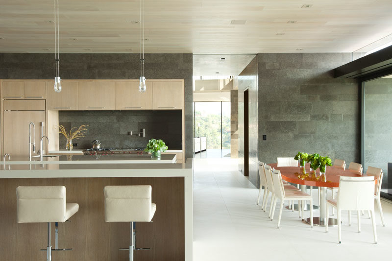 In this modern open plan interior, exterior maple siding has been installed on the ceiling. #WoodCeiling #ModernInterior