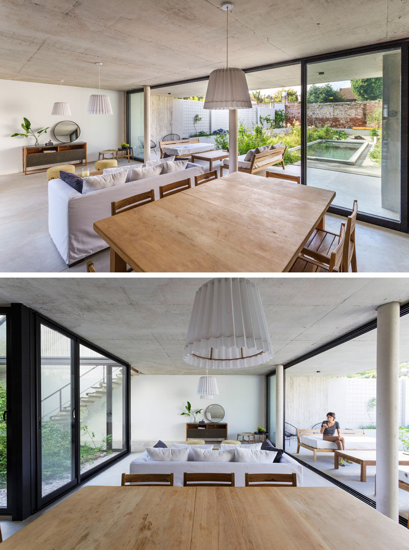 The main social areas of this modern house are open plan, with the living room and dining room sharing the space, while large sliding doors open to the patio and yard, creating an indoor / outdoor living environment. #ModernInterior #OpenPlan #SlidingGlassDoors