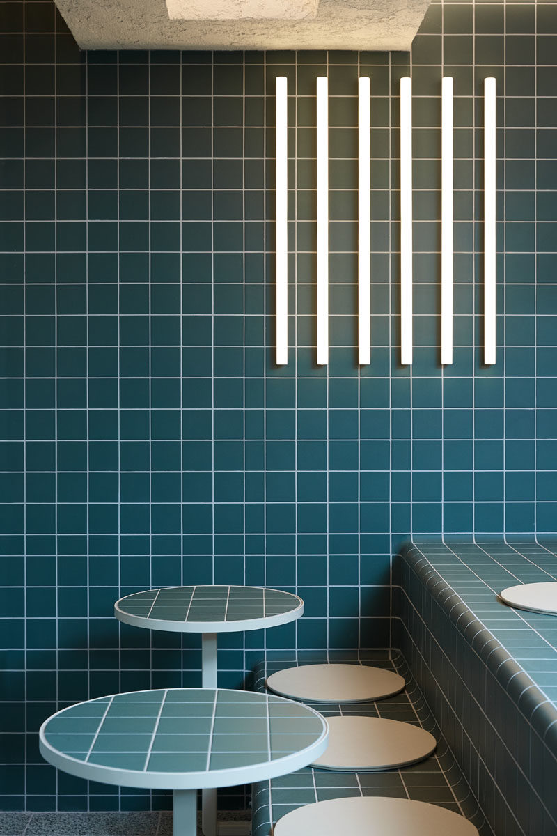 Restaurant Ideas - Deep blue-green tiles have been used throughout this modern restaurant to create a unified appearance that's inspired by retro 60's style and Korean bath houses. #Tile #RestaurantDesign #RestauarantIdeas