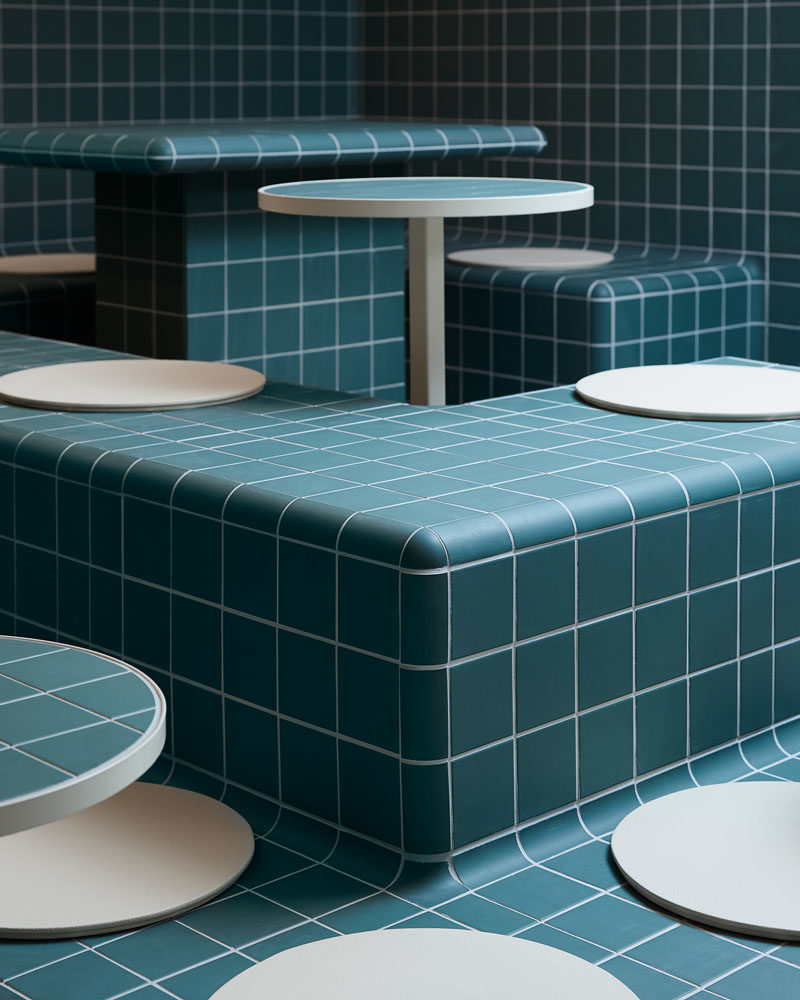 Restaurant Ideas - Deep blue-green tiles have been used throughout this modern restaurant to create a unified appearance that's inspired by retro 60's style and Korean bath houses. #Tile #RestaurantDesign #RestauarantIdeas