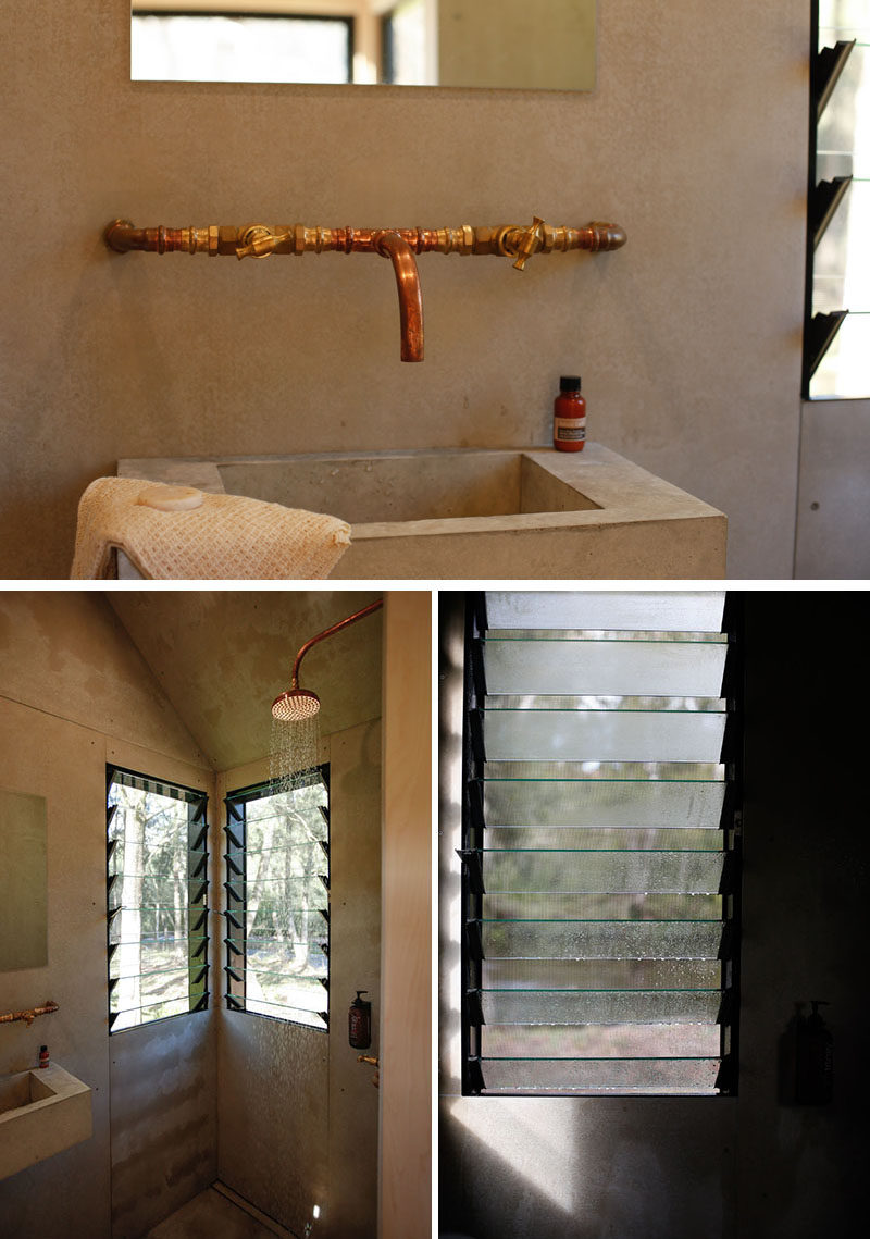 This tiny house has a bathroom that features a concrete basin and copper faucet adds an industrial modern look to the bathroom, while louvre windows in the shower help the air circulate. #TinyHouse #Tinyhome #Bathroom #ConcreteVanity #LouverWindows