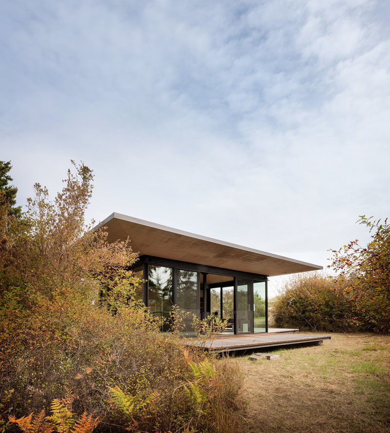 Architecture Ideas - This 500-square-foot glass guest cabin is surrounded by three wooden decks that, through a system of hydraulic winches, wire rope, pivoting sheaves and lead blocks, can be raised to serve as shutters, easily securing the cabin when not in use.  #ArchitectureIdeas #Cabin #ModernCabin #ModernArchitecture