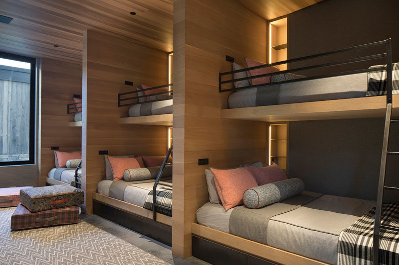 Bunk Bed Ideas - This modern and large bedroom has been designed with custom bunk beds, allowing the room to sleep at least six people, if not more. #BunkBeds #BunkBedIdeas #ModernBunks