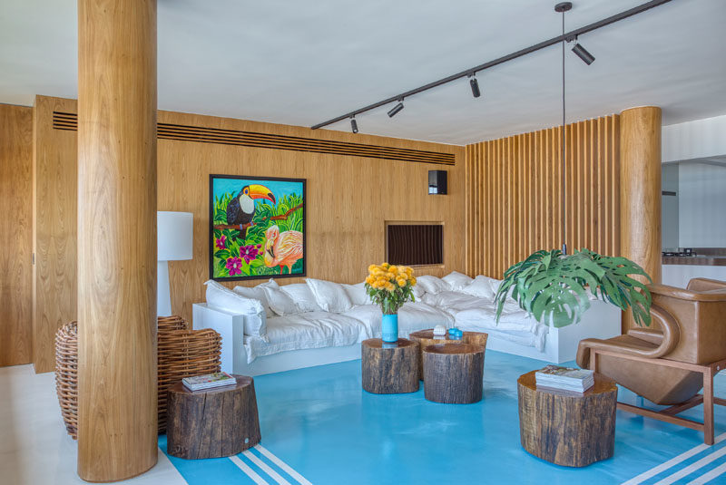 The concrete columns in this modern apartment have been wrapped in wood to match the surrounding wood detailing in the interior, creating a cohesive appearance. #Columns #WoodColumns #InteriorDesign #Interiors