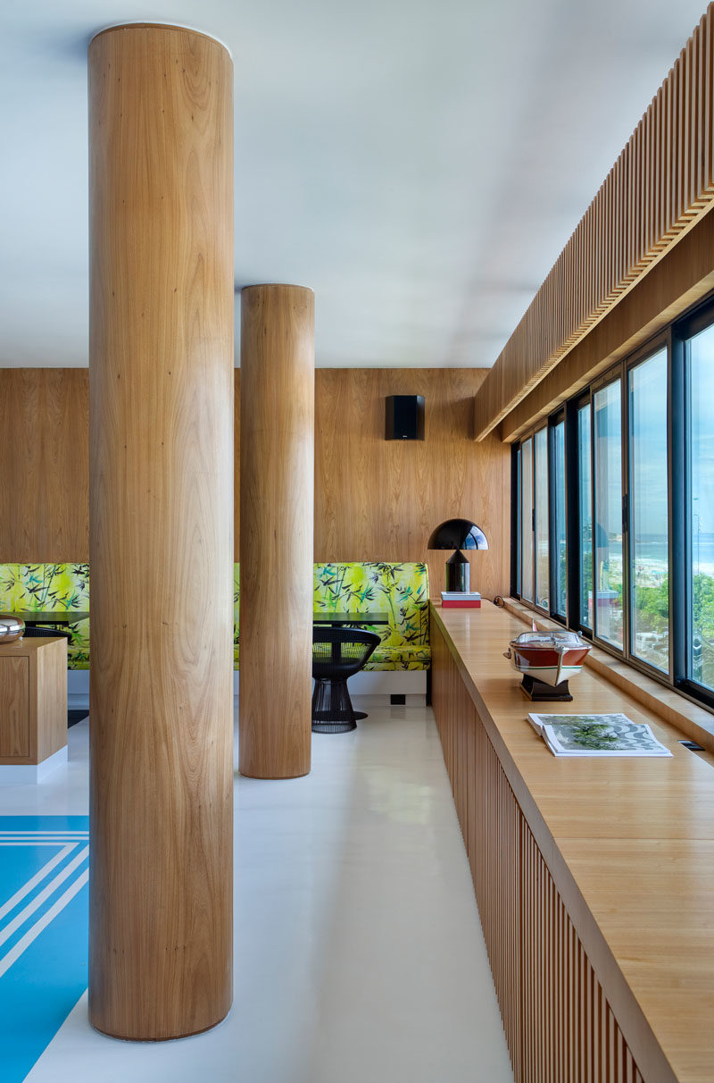 The concrete columns in this modern apartment have been wrapped in wood to match the surrounding wood detailing in the interior, creating a cohesive appearance. #Columns #WoodColumns #InteriorDesign #Interiors