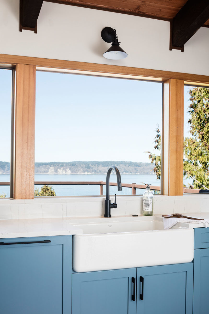 Kitchen Ideas - The designers of this modern light blue kitchen, used LED strip lighting, small flush mounts, and wall sconces, to create a welcoming space. #KitchenIdeas #BlueCabinets #LightBlueKitchen #KitchenDesign #Lighting