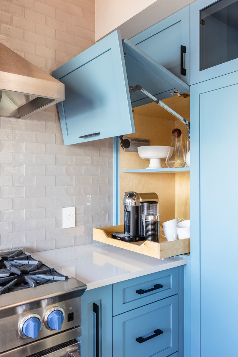 Kitchen Ideas - This modern kitchen with its matte light blue cabinets, has a cupboard with a lift up door, that's dedicated to a coffee station. #KitchenIdeas #BlueKitchen #KitchenDesign #ApplianceGarage #CoffeeStation