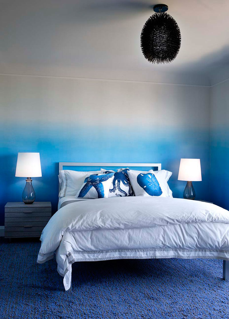 Bedroom Ideas - In this modern bedroom, an ombre accent starts with the bold blue carpet, travels up the wall, and transitions into a soft lavender ceiling. #Ombre #BedroomIdeas #ModernBedroom #BlueBedroom