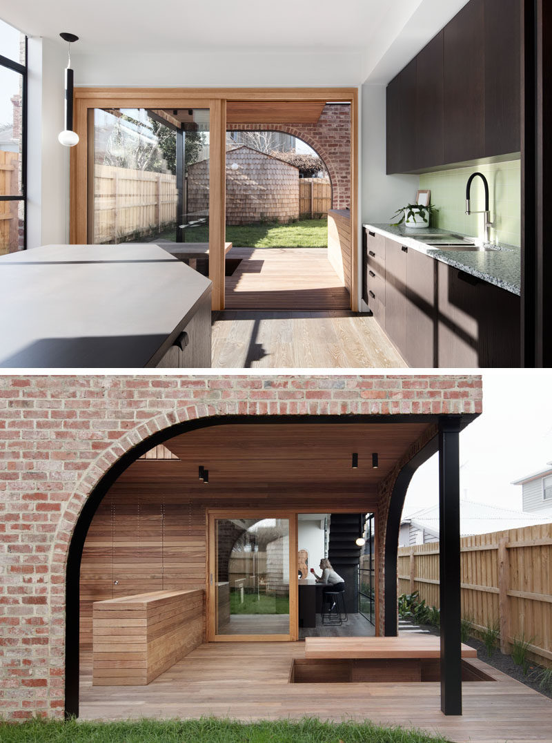 Outdoor Spaces - A large sliding wood-framed glass door opens this modern kitchen to a covered patio, that features a sunken seating area with a table. #Patio #SunkenTable #ModernOutdoorSpace