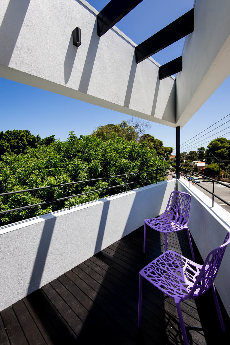 This modern balcony features a black stained timber deck with black stained beams overhead, and a custom steel detailed balustrade. #Balcony #ModernHouse #Architecture