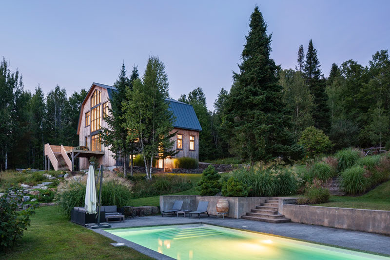 Swimming Pool Ideas - Landscaping surrounds a path that connects a modern barn with the swimming pool and yard. #SwimmingPool #Landscaping