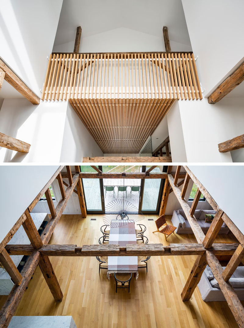 At the top of the stairs in this modern barn, is a balcony that overlooks the dining area below. #InteriorBalcony #ModernBarn #DiningArea