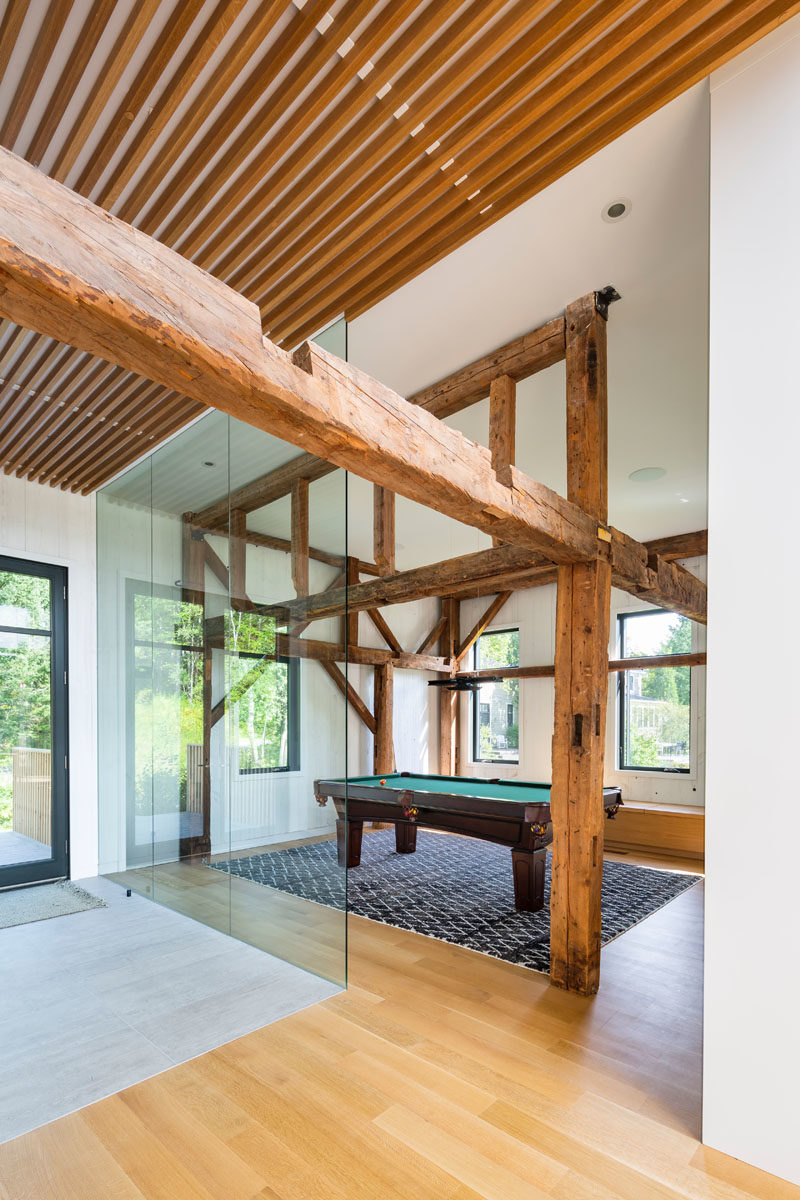 This modern barn has a games room with a pool table, that's located behind a partial glass wall.  #GamesRoom #GlassWall #ModenBarn