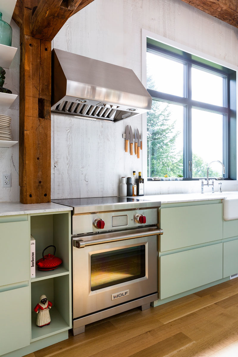 Kitchen Ideas - In this kitchen, whitewashed walls complement the thin floating shelves and light green cabinets. #KitchenDesign #KitchenIdeas #ModernKitchen #BarnKitchen