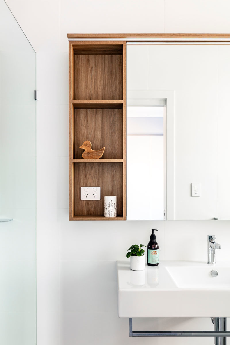 Bathroom Ideas - Open wood shelving provides additional storage and a natural element in this modern bathroom. #BathroomDesign #BathroomIdeas #ModernBathroom