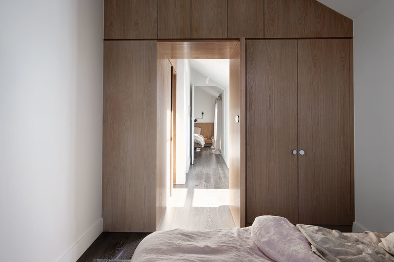 Storage Ideas - This modern bedroom features a custom-built cabinets that wrap around the door and make use of the entire wall. #Closets #StorageIdeas