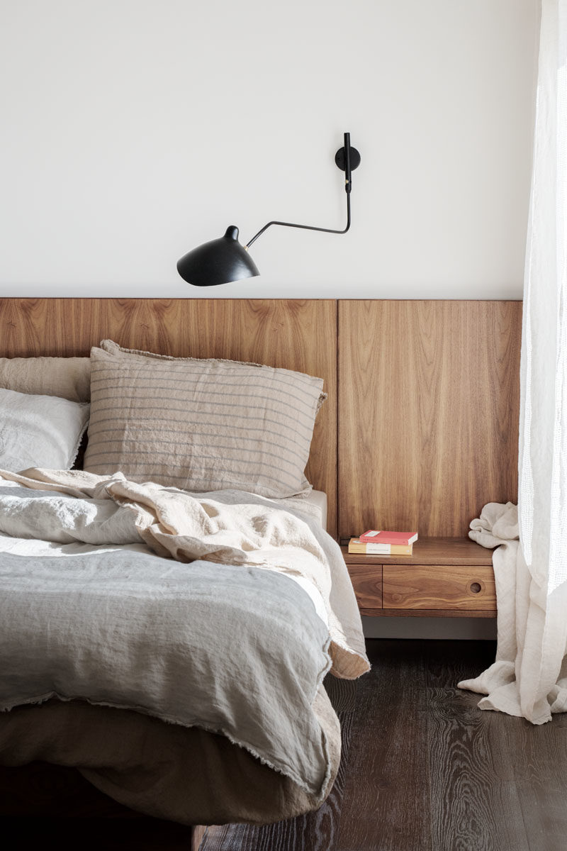 Bedroom Ideas - This modern ebdroom includes a custom designed wood headboard that includes built-in side tables. #ModernBedroom #WoodHeadboard #BedroomIdeas #MasterBedroom