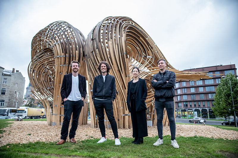 Sculpture Ideas - Using analogue tools augmented with the precision of mixed reality environments, the designers of this modern sculpture were able to create the curved shape that makes the wood appear as if it's flowing. #Sculpture #PublicArt
