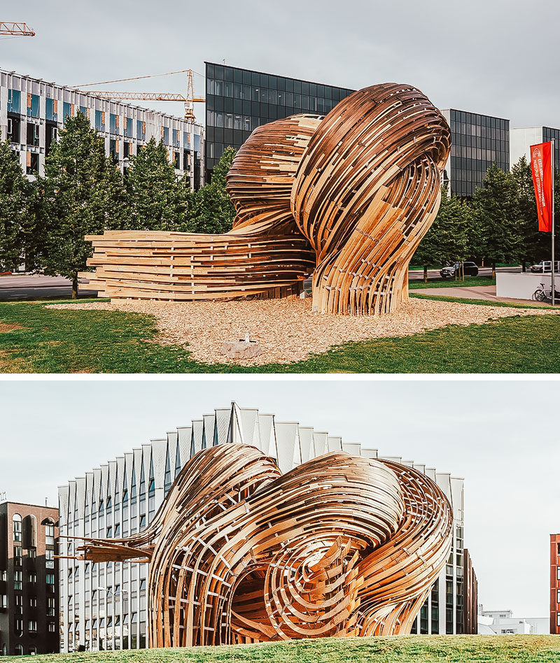 Sculpture Ideas - Using analogue tools augmented with the precision of mixed reality environments, the designers of this modern sculpture were able to create the curved shape that makes the wood appear as if it's flowing. #Sculpture #PublicArt