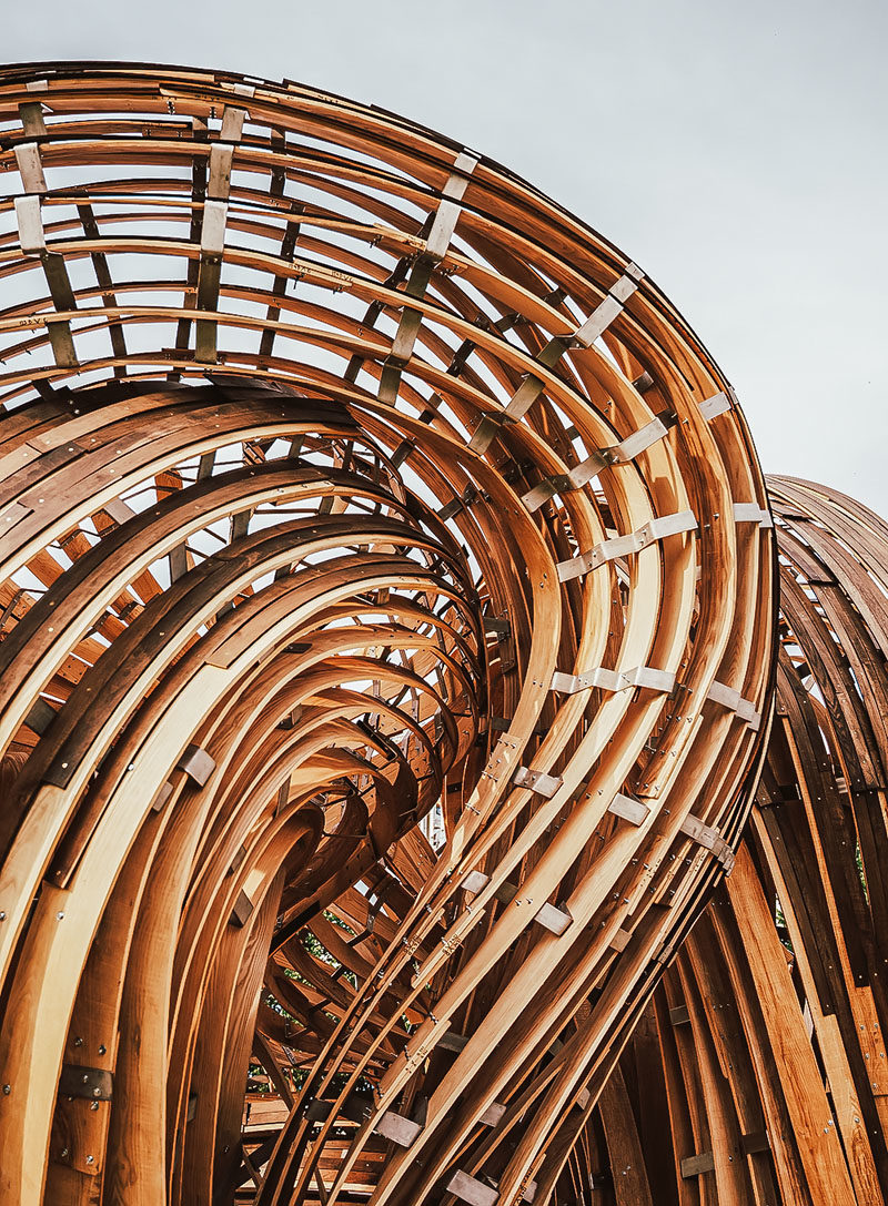 Sculpture Ideas - Using analogue tools augmented with the precision of mixed reality environments, the designers of this modern sculpture were able to create the curved shape that makes the wood appear as if it's flowing. #Sculpture #PublicArt