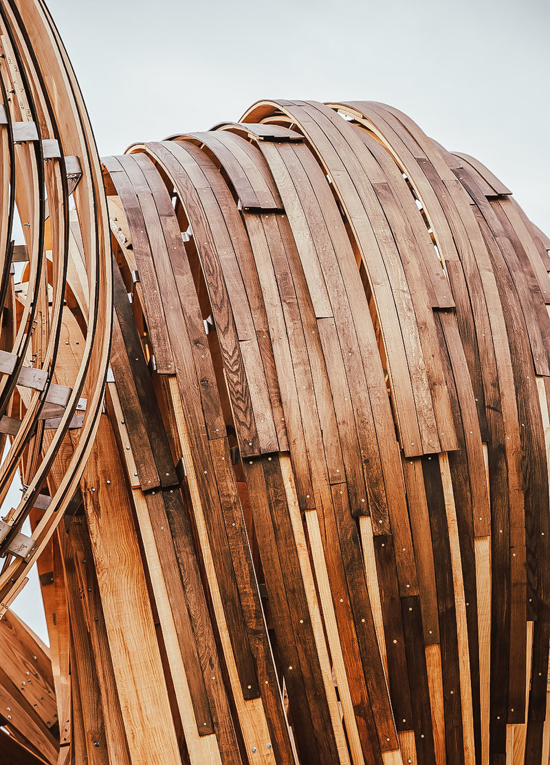 Sculpture Ideas - Using analogue tools augmented with the precision of mixed reality environments, the designers of this modern sculpture were able to create the curved shape that makes the wood appear as if it's flowing. #Sculpture #PublicArt