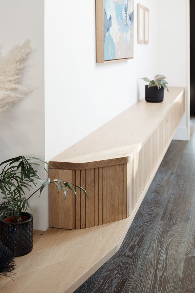 Entryway Ideas - This modern house has a built-in bench by the front door that also includes storage. #Bench #Entryway #InteriorDesign