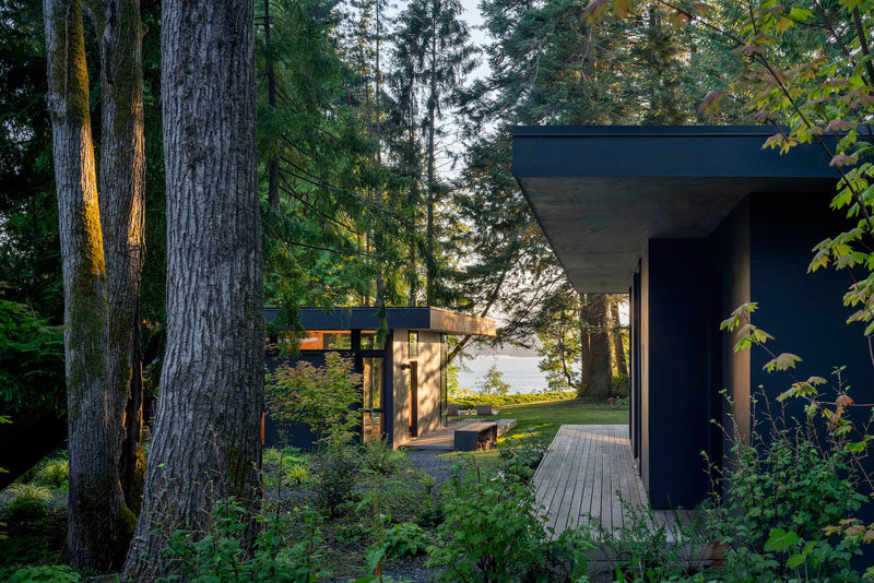 Rough sawn cedar siding and cement panel finishes on the exterior of these cabins will patina naturally over time until the cabin blends in with the colors of the forest. #ModernCabin #ModernArchitecture