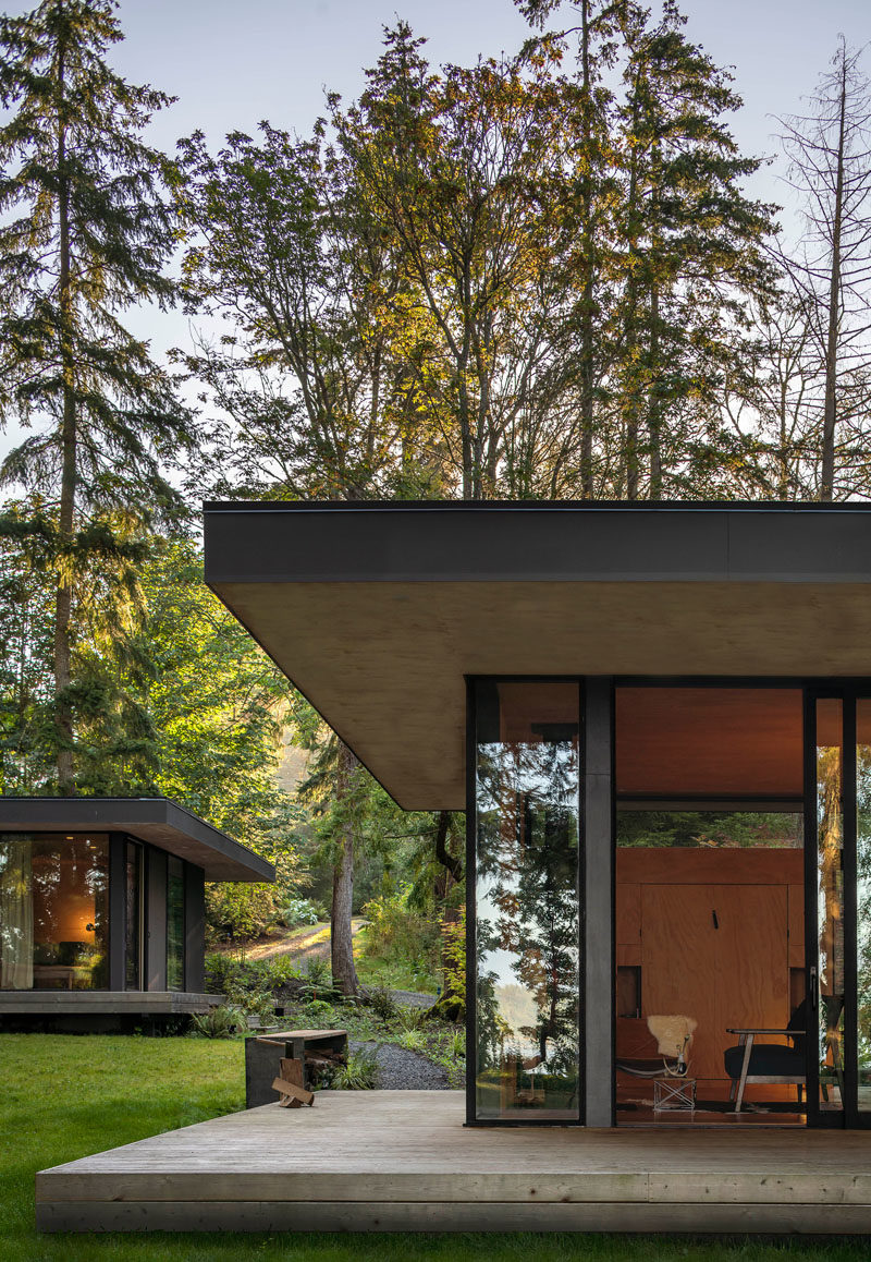 Rough sawn cedar siding and cement panel finishes on the exterior of these cabins will patina naturally over time until the cabin blends in with the colors of the forest. #ModernCabin #ModernArchitecture