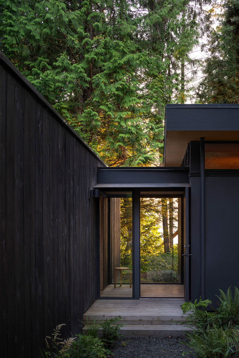 Rough sawn cedar siding and cement panel finishes on the exterior of these cabins will patina naturally over time until the cabin blends in with the colors of the forest. #ModernCabin #ModernArchitecture