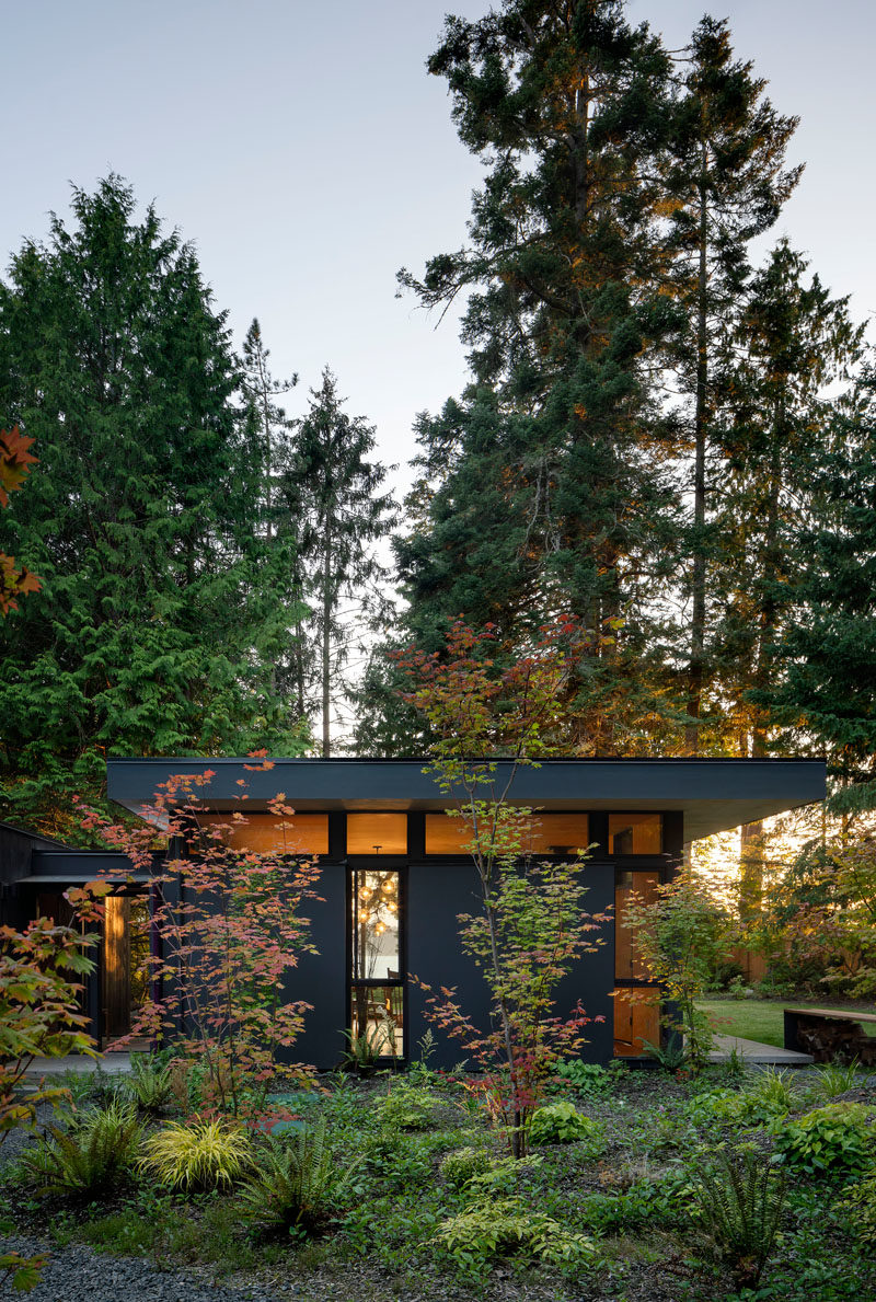 Rough sawn cedar siding and cement panel finishes on the exterior of these cabins will patina naturally over time until the cabin blends in with the colors of the forest. #ModernCabin #ModernArchitecture