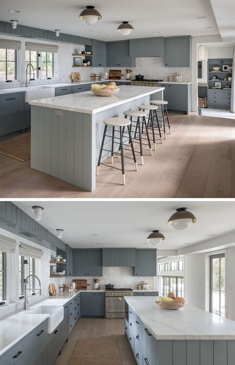 Kitchen Ideas - In this farmhouse-inspired kitchen, the color palette includes greys and white, with an apron sink adds to the farmhouse look of the home, and a large island adds room for people to sit and socialize while cooking. #KitchenDesign #KitchenIdeas #GreyAndWhiteKitchen #FarmhouseModern #ModernFarmhouse