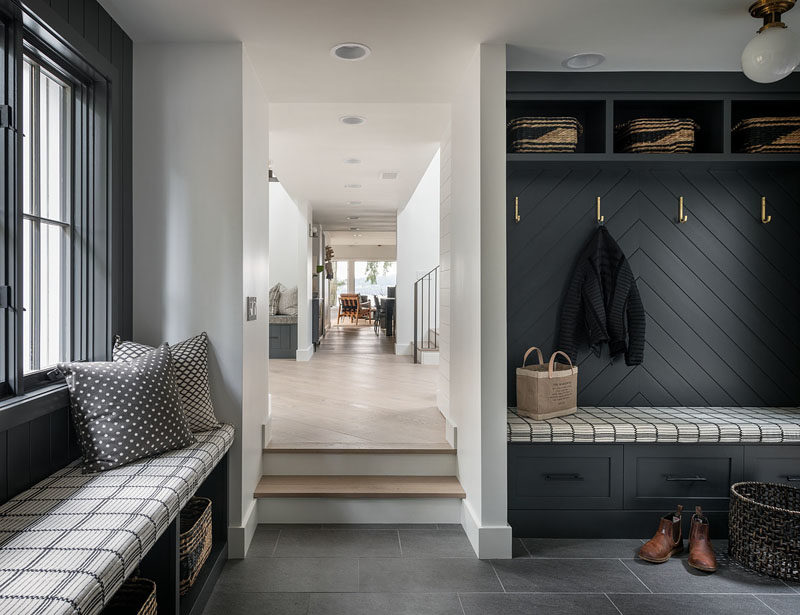 Mudroom Ideas - This modern mudroom has built-in benches, and storage nooks provide a place to keep jackets and shoes organized. #Mudroom #MudroomIdeas #ModernMudroom