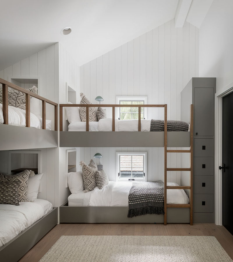 Bedroom Ideas - This modern bedroom has been furnished with custom-designed bunk beds. Each bunk bed has a built-in shelf at the head of the bed, and a minimalist wood ladder for easy access. #BedroomIdeas #BunkBeds #Bunks