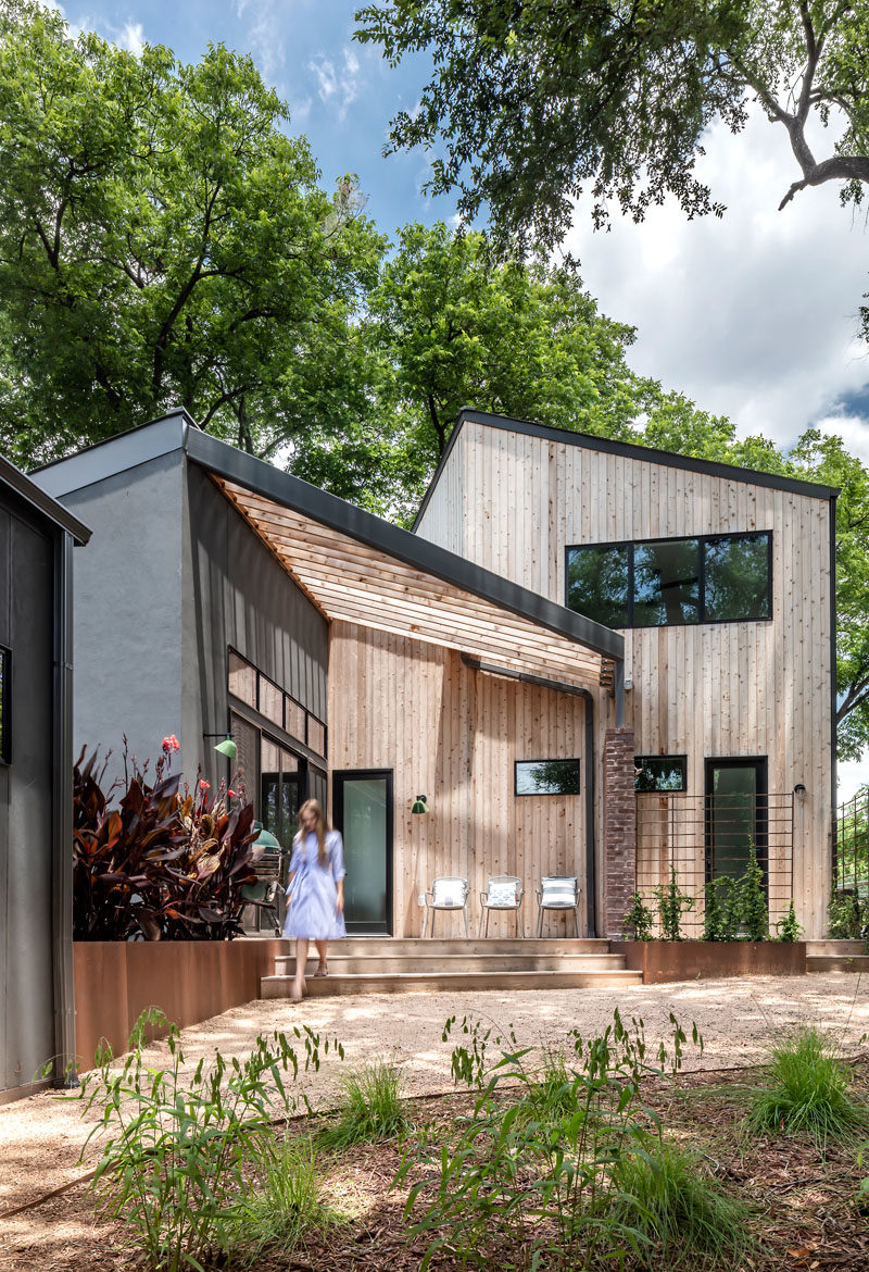 Sliding glass doors connect the interiors to outdoor spaces, that showcase the exterior materials of this modern house, like the knotted cedar tongue & groove siding, and the dark gray shade of stucco that provides contrast to the wood. #ModernHouse #ModernArchitecture #HouseDesign