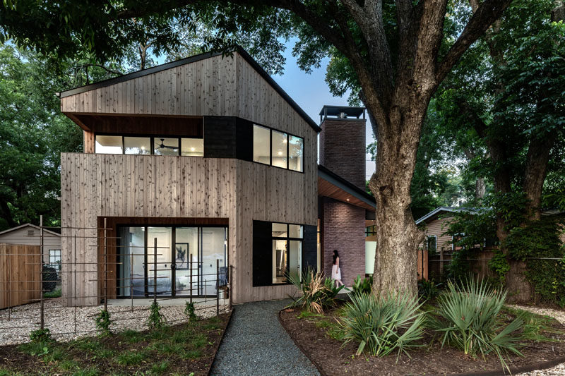 This modern house features materials like knotted cedar tongue & groove siding, brick, and dark gray stucco. #ModernHouse #HouseDesign #Architecture