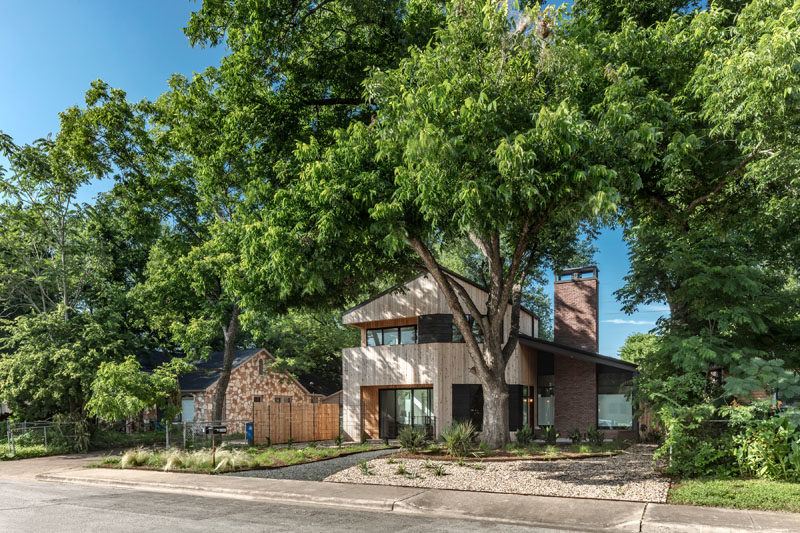 This modern house features materials like knotted cedar tongue & groove siding, brick, and dark gray stucco. #ModernHouse #HouseDesign #Architecture