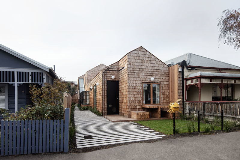 Mani Architecture has designed a modern cottage-like house in Melbourne, Australia, that's covered in wood shingles and features a built-in table and chairs in the front garden. #Shingles #ModernHouse #HouseDesign #Architecture