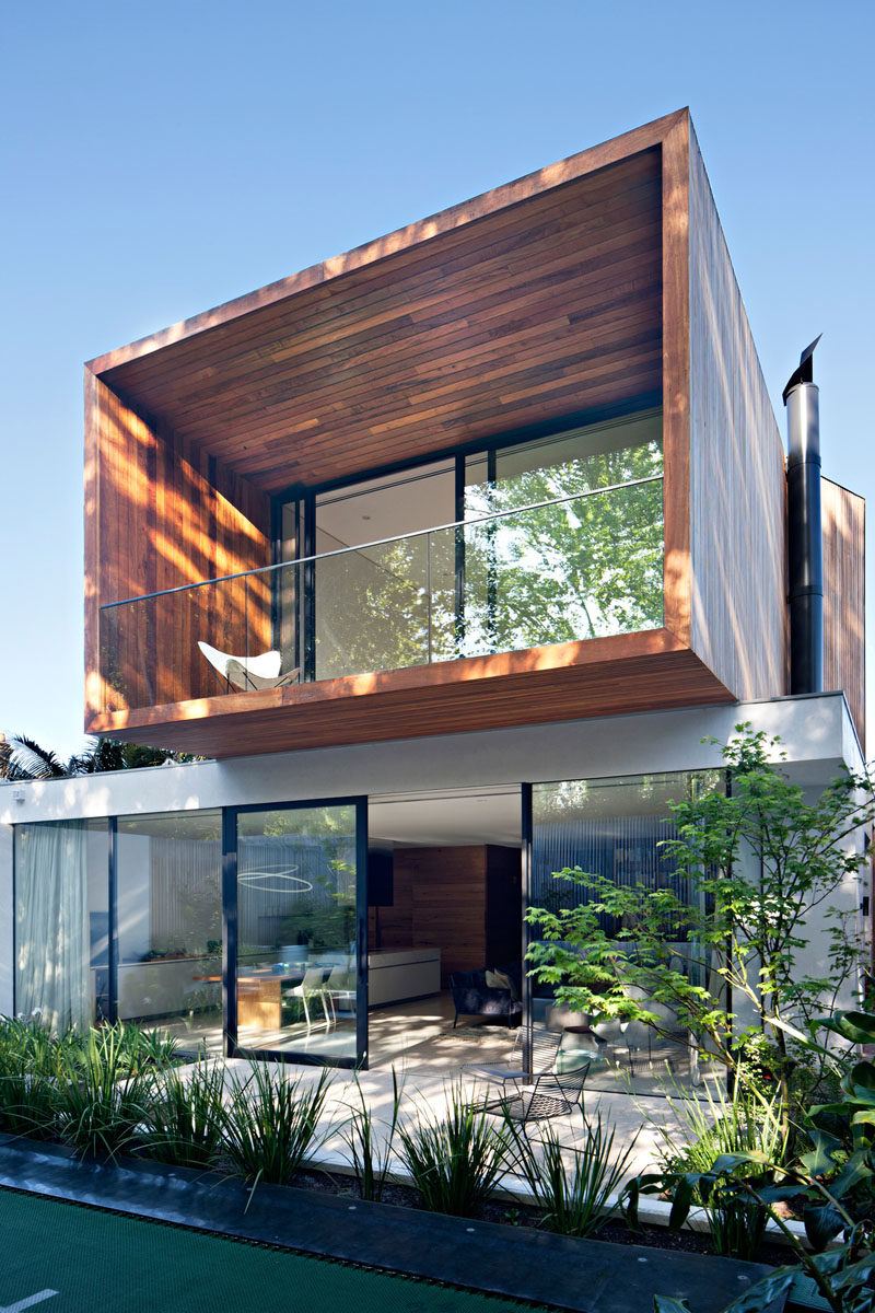 Architecture Ideas - Both the living room and kitchen of this house open up to a patio and the garden, where you're able to see the new cantilevered wood addition. #Cantilever #Architecture #ModernAddition