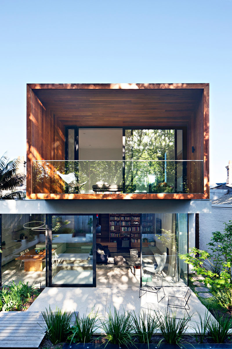 Architecture Ideas - Both the living room and kitchen of this house open up to a patio and the garden, where you're able to see the new cantilevered wood addition. #Cantilever #Architecture #ModernAddition