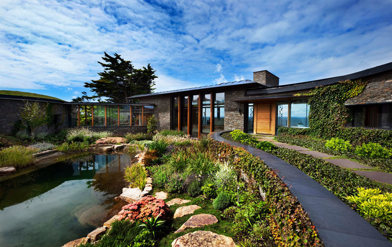 Landscaping Ideas - A natural swimming pool surrounded by plants and rocks, provides a unique outdoor experience for the home owners. #Landscaping #LandscapeDesign #NaturalSwimingPool #SwimmingPool #PoolIdeas