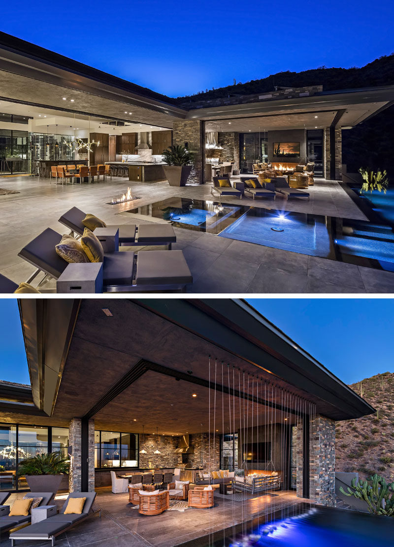 The flooring of this modern house, flows from inside the home seamlessly transitions to the outdoor spaces that wrap around the pool. A rainfall water feature is located beside the outdoor living room, that also has a bbq and dining area. #SwimmingPool #Flooring #Architecture #OutdoorLivingRoom #Fireplace