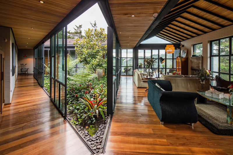 Garden Ideas - Nestled within the mountains, the layout of this modern black house provides a space for an open interior garden. #Garden #InteriorGarden #HouseDesign