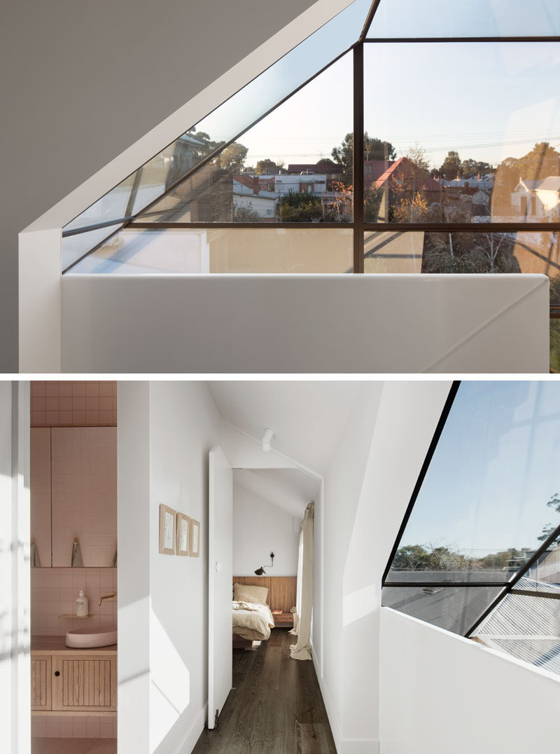 Window Ideas - At the top of the stairs in this modern house, there's windows that form part of the roof, and provide a view of the neighborhood. #WIndows #WindowDesign #WindowIdeas