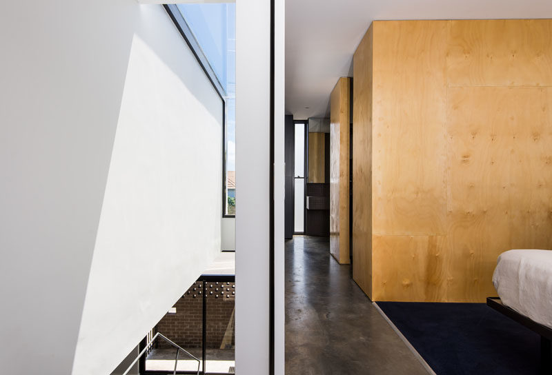 This master bedroom is located at the top of the stairs, and makes use of wood to add a warmth to the space. #InteriorDesign #ModernInterior