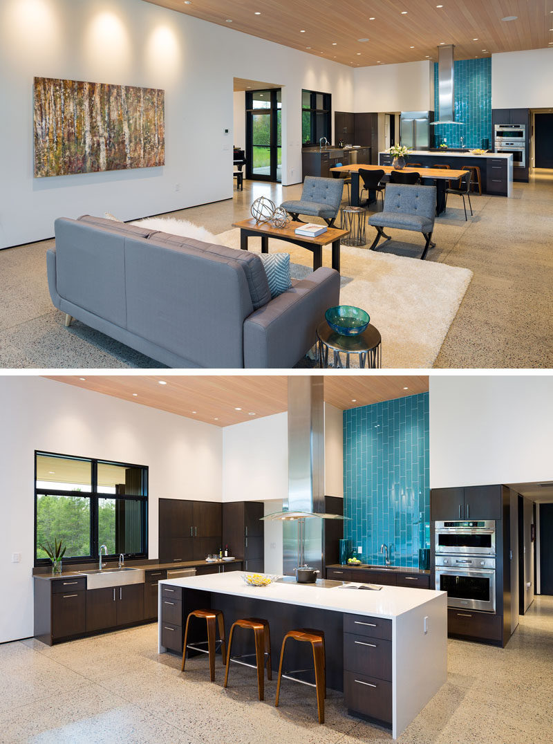 Kitchen Ideas - Blue tiles in this modern kitchen draw the eye to the opposite end of the open plan room, where a large island provides additional space for counter stools and storage. #ModernKitchen #KitchenDesign #KitchenIdeas #BlueBacksplash