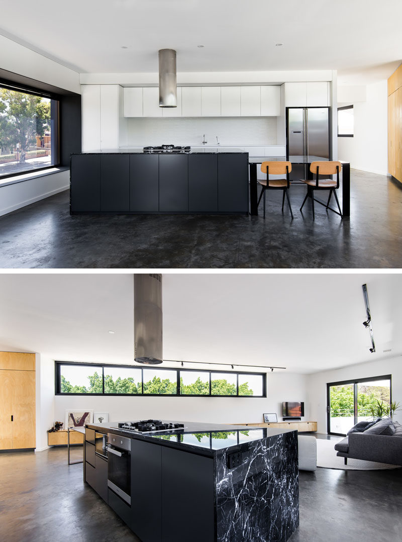 Kitchen Ideas - Minimalist black and white cabinetry has been used in the kitchen, while the kitchen table is able to be moved when required. Marble bench tops complement the black powder coated steel and concrete floors. #ModernKitchen #KitchenIdeas #KitchenDesign