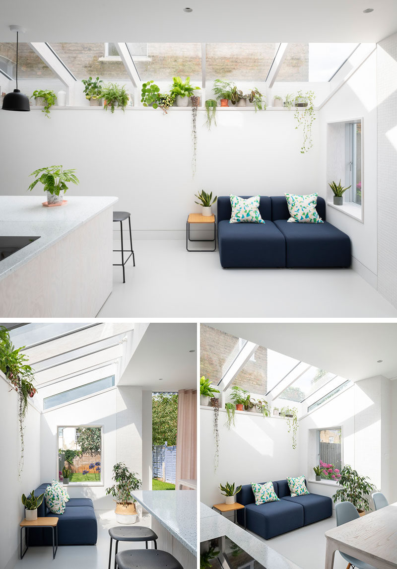 Inside this modern rear house extension, the material palette has been kept minimal with whitewashed Douglas Fir joinery and a seamless resin floor. The use of Douglas fir continues for the structural fins and window reveals, while a plant shelf runs the length of the extension and takes advantage of the light from the windows. #WhitewashedWood #ModernInterior #PlantShelf #Windows #RearExtension #HouseExtension