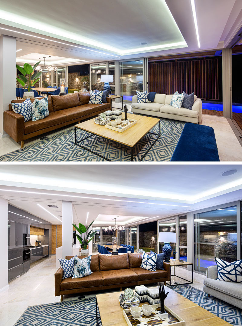 Living Room Ideas - Inside this modern house, glass walls walls connect to the outdoor spaces, while in the living room, recessed ceilings draw attention due to the hidden lighting. #ModernLivingRoom #LivingRoomIdeas #LivingRoomDesign