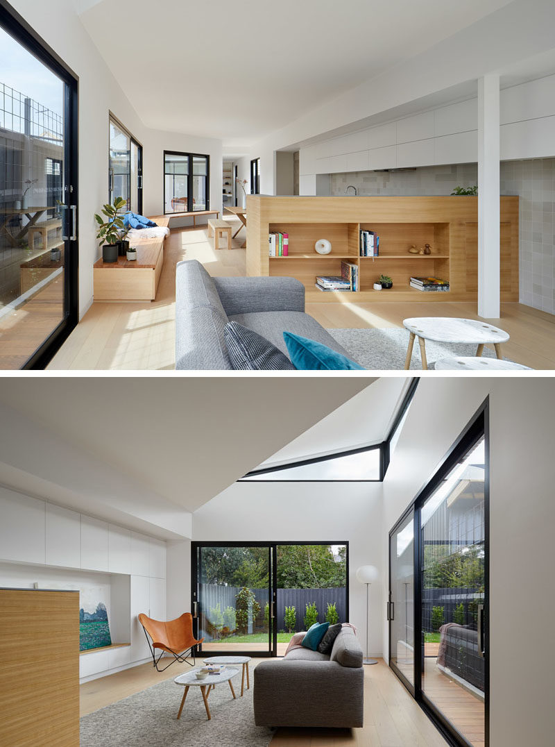 Living Room Ideas - In this modern house extension, a low wood wall between the kitchen and living room provides open shelving for displaying decor. The white kitchen cabinets continue through to the living room too, and incorporate a built-in bench. #HouseExtension #LivingRoom #InteriorDesign
