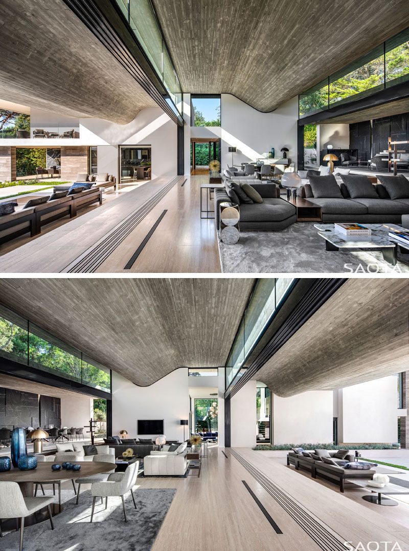 Clerestory windows fill this modern house with natural light, provide views of the trees, and draw the eye upwards to the wavy concrete ceilings. #Windows #ClerestoryWindows #WindowIdeas #ConcreteCeiling #InteriorDesign